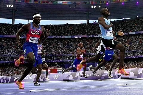 Letsile Tebogo, of Botswana, right, wins the men's 200-meters gold